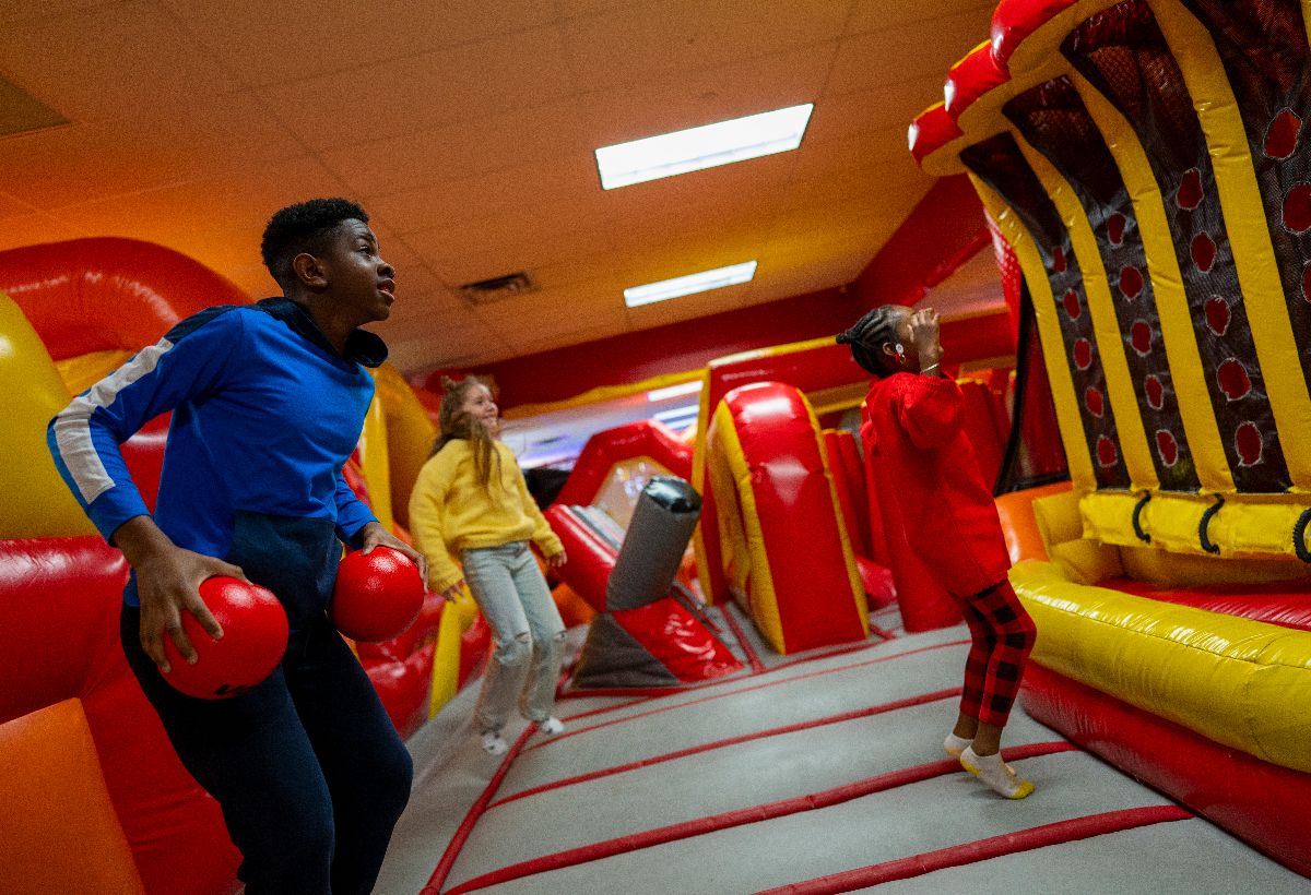 Guests playing inside the Laser Bounce inflatable attraction area